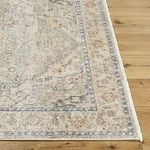 Close-up detail of rug edge and corner with visible weave texture and color variations on wood floor