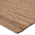 Close-up at edge of solid tan variant highlighting thick woven jute and rayon fibers