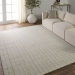 Highgate rug styled in a living room with beige sectional sofa and wooden floors