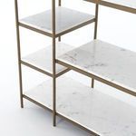 Clean studio front angle of console table with marble shelves and brass frame