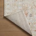 Edge of rug partially lifted to show woven underside and neat edge finishing
