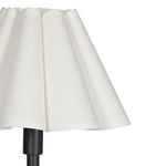 Close-up of white scalloped fabric shade showing texture and pleated design