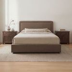 Simon Storage Bed styled in bedroom with beige bedding, two wooden nightstands, and neutral rug