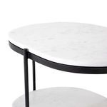 Close-up of top marble oval shelf and iron vertical support rods of Felix Oval Nightstand
