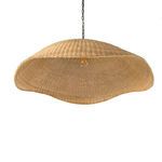 Front view underneath pendant showing rattan weaving and soft natural color with lit bulb inside