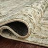 Rolled edge of rug with softly textured pile and visible fabric backing on wood floor