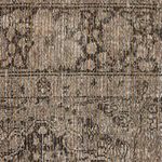 Extreme close-up of rug fibers showing woven jute texture with beige and browned threads