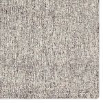 Detailed view of rug surface displaying fine tweed texture and tonal gray and cream yarn mix