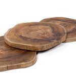 Angled side view of three overlapping teak trays showing natural wood tones and texture
