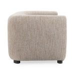 Profile side view highlighting rounded armrest and fabric texture with neutral tones