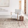 Rug laid out in a bright, minimalist living room with light furniture and natural wood accents