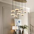 Harper Console with pendant light fixtures overhead, styled with art, plants, and lamp in a living space