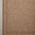 Close-up of the rug's woven texture and border on a smooth floor