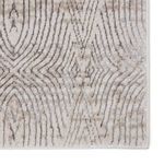 Close-up of rug corner highlighting detailed gray and taupe pattern and finished edge
