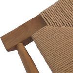 Close-up angle of teak frame corner with woven wicker seat anchored tightly