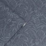 Close-up showing wallpaper rolled to highlight texture and pattern continuity