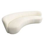 Three-quarter top angle emphasizing the sofa’s curved shape and continuous upholstery