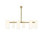 Chandelier illuminated, showing warm glow of matte glass cylinders on burnished brass