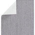 Back side of rug showing white backing material and folded corner