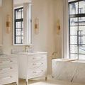 Verona vanity shown in a bright bathroom setting with large arched window and matching marble bathtub surround