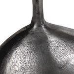 Close-up of rounded metal base displaying detailed textured and hammered silver metal finish