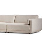 Angled side detail of Toland sectional showing armrest, base, and seat cushion join in textured fabric