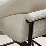 Curved seamless upholstery on armrest blending into seat cushion