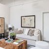 Living room with Atlas Marble Chain sculpture on wood coffee table with neutral furnishings