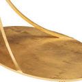 Close-up of textured gold base with curved supports casting shadows