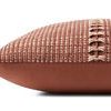 Side view of pillow showing smooth solid reddish-brown fabric on back and plump profile