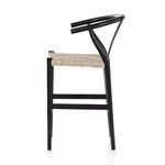 Three-quarter rear angle showcasing the black teak frame and woven seat texture