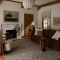Milena Linen Midnight Rug styled in a warm living room with brown sofa and large windows