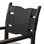 Close-up detail of the sculptural rope wrapping on the chair’s backrest with wood grain visible