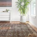 Layla rug in bright room with wood floor, viewed at angle showing texture and subtle patina