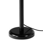 Detailed view of the black round metal base of the Watkins Floor Lamp with cord