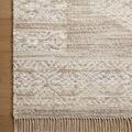 Corner of Rivers Lilac / Ivory Rug on wooden floor highlighting fringe and woven wool texture