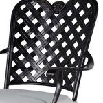 Detailed view of curved lattice back with floral medallion above armrest