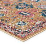 angled close-up showing rug’s low pile texture and stitched edge detail with vibrant color accents