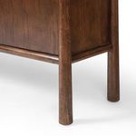 Close-up on the rounded leg and lower support rail connecting the sideboard legs