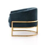 Side shot of Corbin Chair with velvet upholstery, highlighting the brass curved base