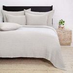 Bedroom setting featuring the Vancouver Sham on a made bed with matching grey quilt and black headboard