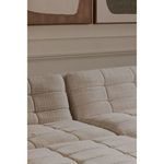 Full view of sectional sofa with Lino slipper chairs arranged with round wooden coffee table