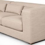 Close-up on left armrest corner with visible upholstery texture and cushion joints