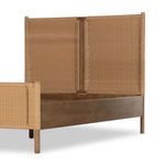 Angled view highlighting woven rattan footboard panel and solid wood legs