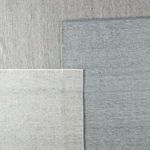 Overhead view comparing the light gray rug with two other rug colorways in darker gray shades