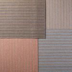 Four rugs in different color variations including rose, taupe, blue, and dark taupe