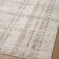 angled close-up showing cross pattern and color variation in soft ivory rug near edge