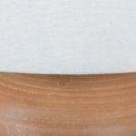 Area where linen shade meets top of terracotta base showing fabric texture and earthy clay color