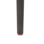 Bottom close-up of dark weathered oak chair leg with protective glider cap