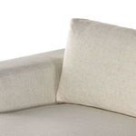 Close-up on corner between padded arm and back cushion showing fabric and cushion thickness